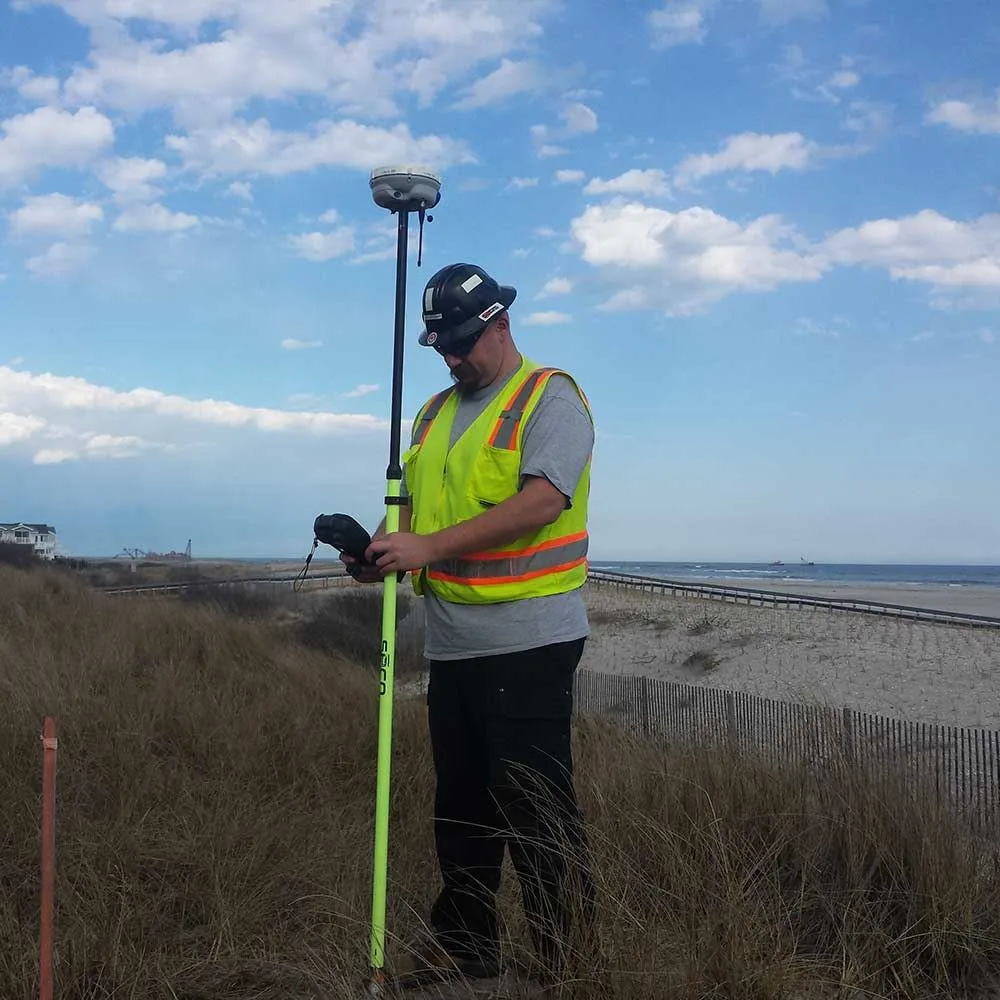 GBA coastal engineer surveying beach dunes